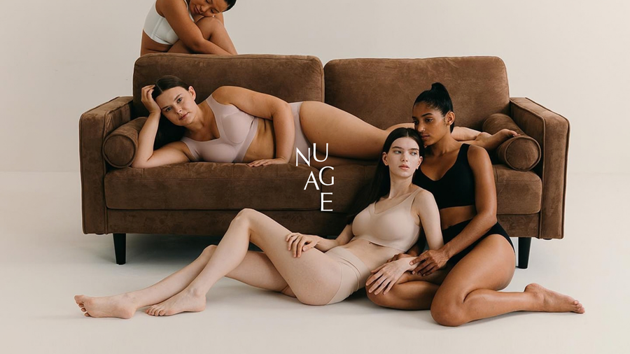Four models wearing Nuage underwear around a brown sofa in a brand campaign