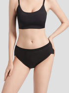 Woman wearing black NuCycle Leak Proof Brief and matching black top, full-coverage cotton underwear with built-in leak-proof lining for period protection