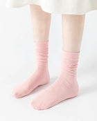 Pink ribbed stacked mid-calf socks made of soft breathable fabric with antibacterial properties and seamless toe design.