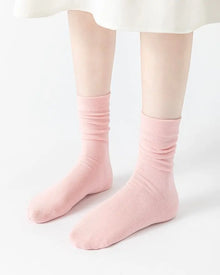Pink ribbed stacked mid-calf socks made of soft breathable fabric with antibacterial properties and seamless toe design.