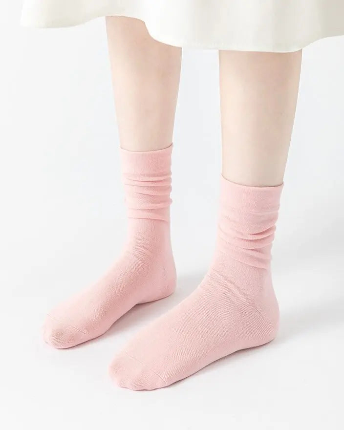 Pink ribbed stacked mid-calf socks made of soft breathable fabric with antibacterial properties and seamless toe design.